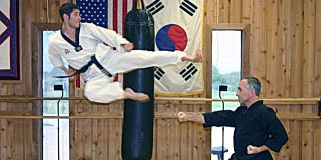 Master David Kestenbaum executing a flying side kick during a demonstration